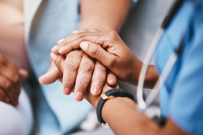 Empathy, trust and nurse holding hands with patient for help, consulting support and healthcare advice. Kindness, counseling and medical therapy in nursing home for hope, consultation and psychology.