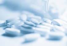 Prescription medicine pill bottle and pills. opioids