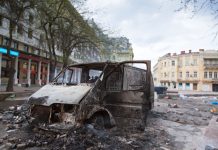 Burned car in the center of city after unrest
