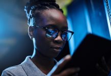 Shot of a young female engineer using a digital tablet while working in a server room