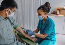 Nurse preparing patient to do a blood analysis