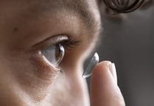 Close up of Young Male Adult Putting in Contact Lens