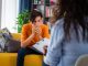 Female psychologist counseling teenage boy in office, Young people's mental health