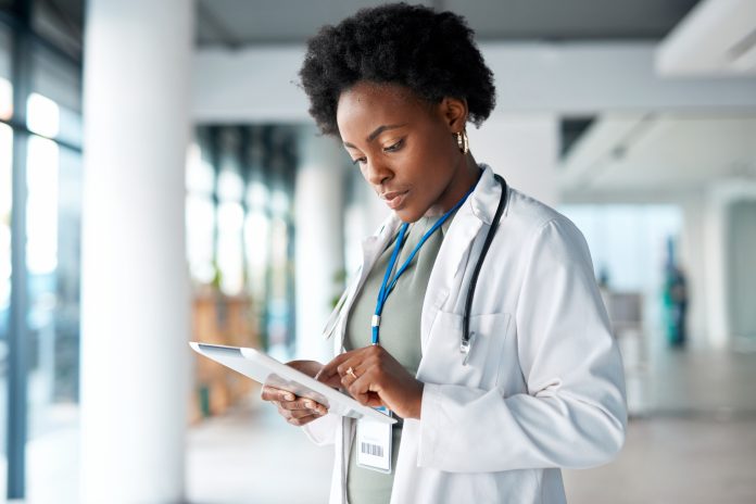 Healthcare, doctor and black woman on tablet in hospital for telehealth, research and online prescription. Hospital, clinic and female with digital tech for medical app, data analysis and insurance