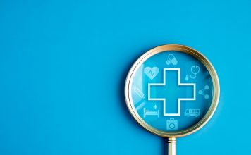 Healthcare service, hospital website online search, wellness plan and insurance concept. Health, care and medical element icon symbols in magnifying glass lens on blue background with copy space.