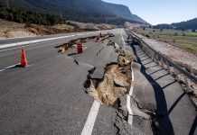 Asphalt road collapsed and cracks in the roadside