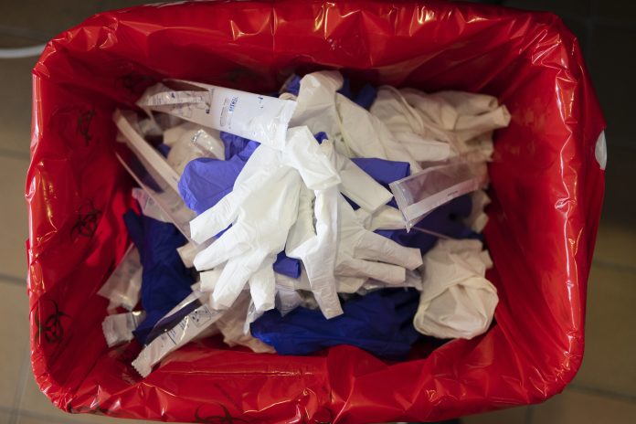 Waste in a covid 19 test sleeve bin