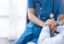 Cropped shot of a female nurse hold her senior patient's hand. Giving Support. Doctor helping old patient with Alzheimer's disease. Female carer holding hands of senior man