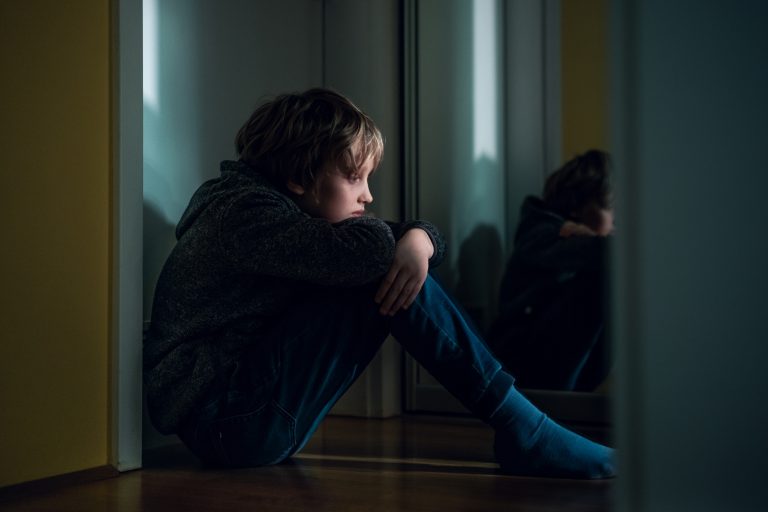 Sad boy at home. Depression or anxiety concept. - child poverty