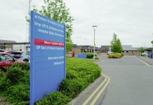 Large NHS hospital direction and information sign seen within the hospital campus in the East of England.