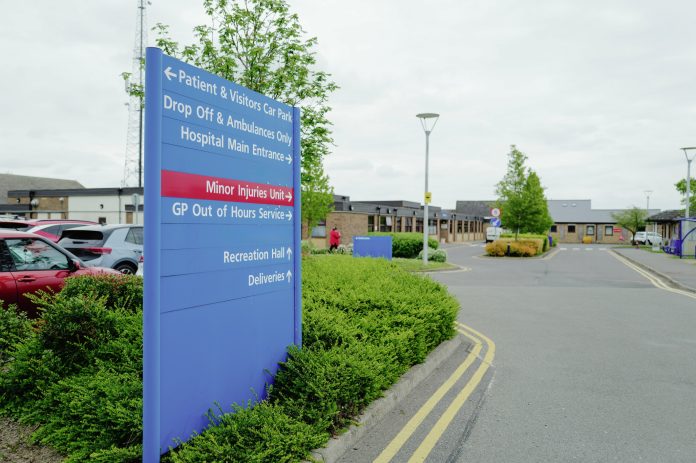 Large NHS hospital direction and information sign seen within the hospital campus in the East of England.