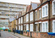 Traditional English terraced houses with huge council block in the background