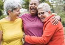 Multiracial senior women having fun together after sport workout outdoor - Main focus on african female face