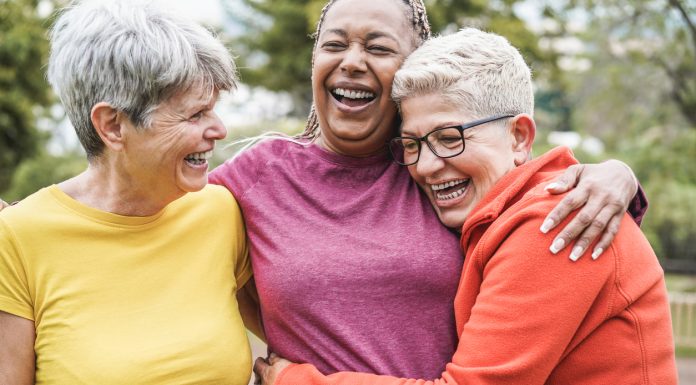 Multiracial senior women having fun together after sport workout outdoor - Main focus on african female face