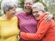 Multiracial senior women having fun together after sport workout outdoor - Main focus on african female face