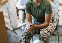 Close up photo female soldier leaning forward in seat