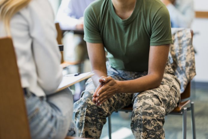 Close up photo female soldier leaning forward in seat