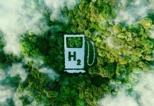 A lake in the shape of a hydrogen filling station used as a concept to illustrate the environmental friendliness of hydrogen and its potential as the fuel of the future. 3d rendering.