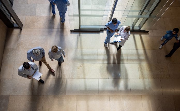 Patients and doctors coming in and out of the hospital