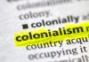 Close up photo of the word colonialism in a dictionary book