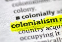 Close up photo of the word colonialism in a dictionary book