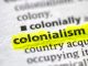 Close up photo of the word colonialism in a dictionary book