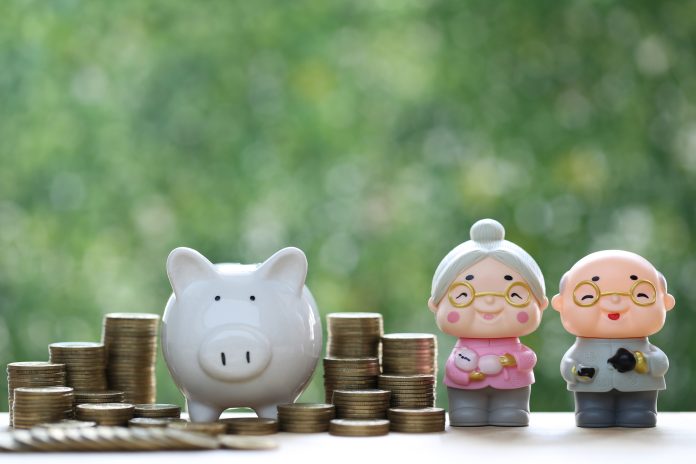 Mutual fund,Love couple senior with stack of coins money and piggy bank on green background, Save money for prepare in future and pension retirement concept