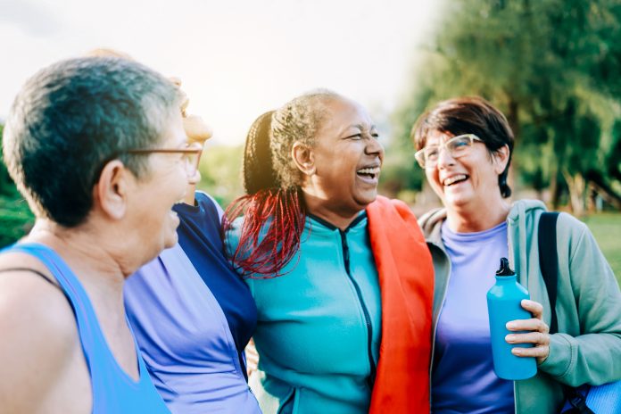 Senior sport people having fun after exercising in yoga class outdoor at park city - Fitness joyful Elderly lifestyle