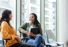 Cheerful counselor listening to patient