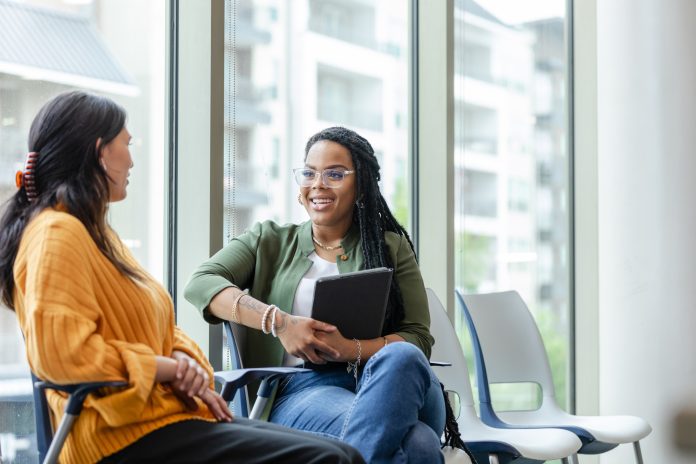 Cheerful counselor listening to patient