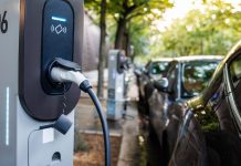 Charging EV with cable at the station in the street