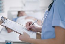 Nurse tending patient in intensive care