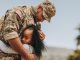 Affectionate military reunion between father and daughter. Emotional military dad embracing his daughter on his homecoming. Army soldier receiving a warm welcome from his child after deployment.