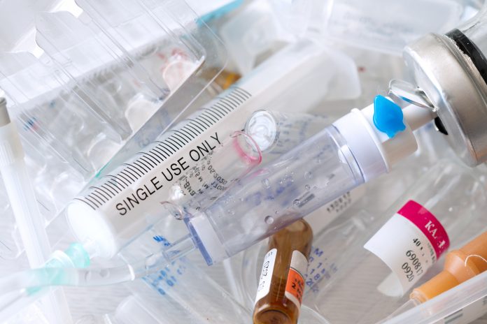 medical syringes and ampoules of plastic and glass that were in use, waste, close-up.