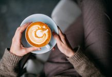 Flat Lay Woman Hand Holding Coffee Latte