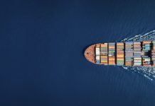 Aerial top down view of a large container cargo ship with copy space