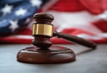 Close up of wooden judge gavel over the american flag with copy space