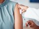 Hands, medical and doctor with patient for vaccine in a clinic for healthcare treatment for prevention. Closeup of a nurse doing a vaccination injection with a needle syringe in a medicare hospital.