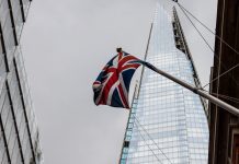 Typical London view: grey clouds before the rain, the Union Jack, and the Shard seen from below