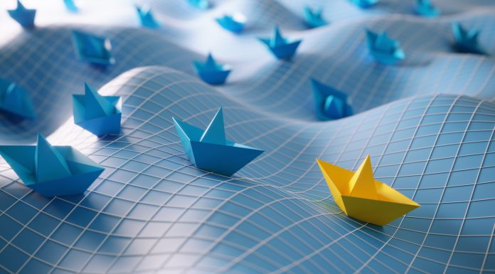 Blue colored paper boats and yellow colored one in the first place, can be used leadership/individuality concepts. (3d render)