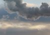 Heat station pipes, smoke. Smoking pipes, white smoke. Gray dramatic sky sky as background. Chimneys, concept of industry and ecology, heating season, global warming. Panoramic image