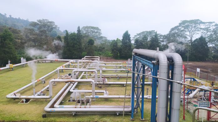 Geothermal steam energy factory, renewable green energy industry. Geothermal steam power plant, steam pipelines, alternative renewable energy in the world. kamojang, West Java, Indonesia.