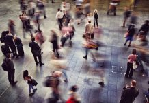 Blurred Motion Of People Walking At Railroad Station