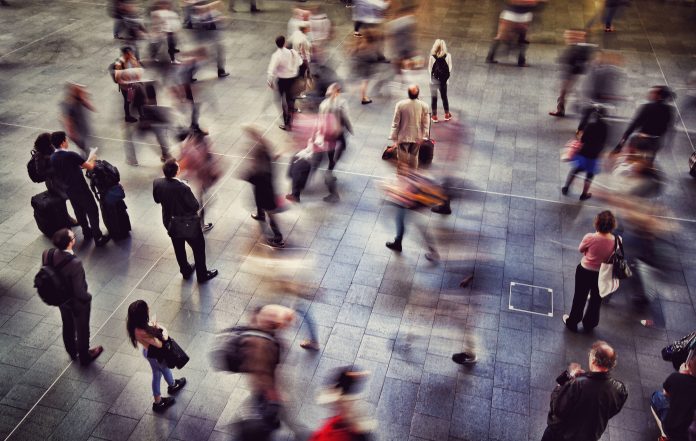 Blurred Motion Of People Walking At Railroad Station