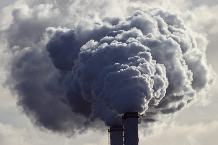 Air pollution from power plant chimneys.