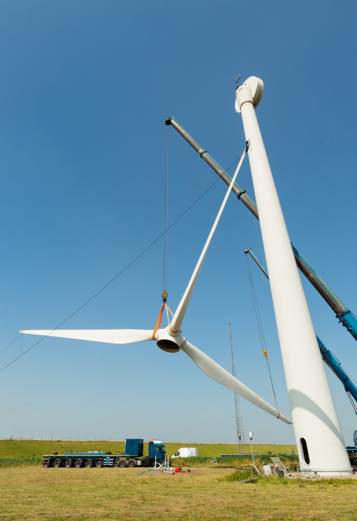 Low angle view of wind turbine being dismantled