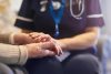 Nurse comforting senior patient