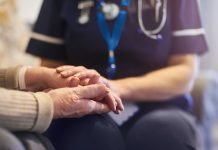 Nurse comforting senior patient