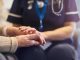 Nurse comforting senior patient