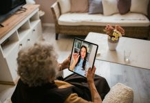 Young medical practitioner on a video call with her senior patient